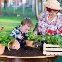 A woman and a kid repotting plants - Featured image for 